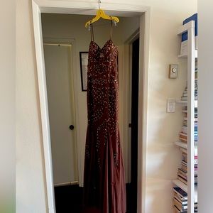 SHOW STOPPER. Brown dress with copper-y bedding. Bodice has semi-sheer cutouts.